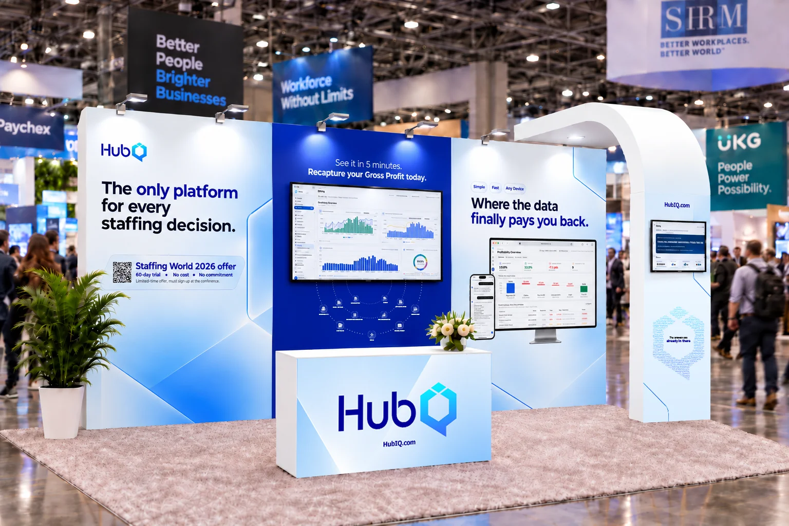 Rendered view of the HubIQ exhibit booth at Staffing World 2026: white and blue panels with HubIQ messaging, screens showing the HubIQ dashboard, a white counter with the HubIQ logo, and a white arched tower, set on a busy expo floor with attendees and neighboring booths